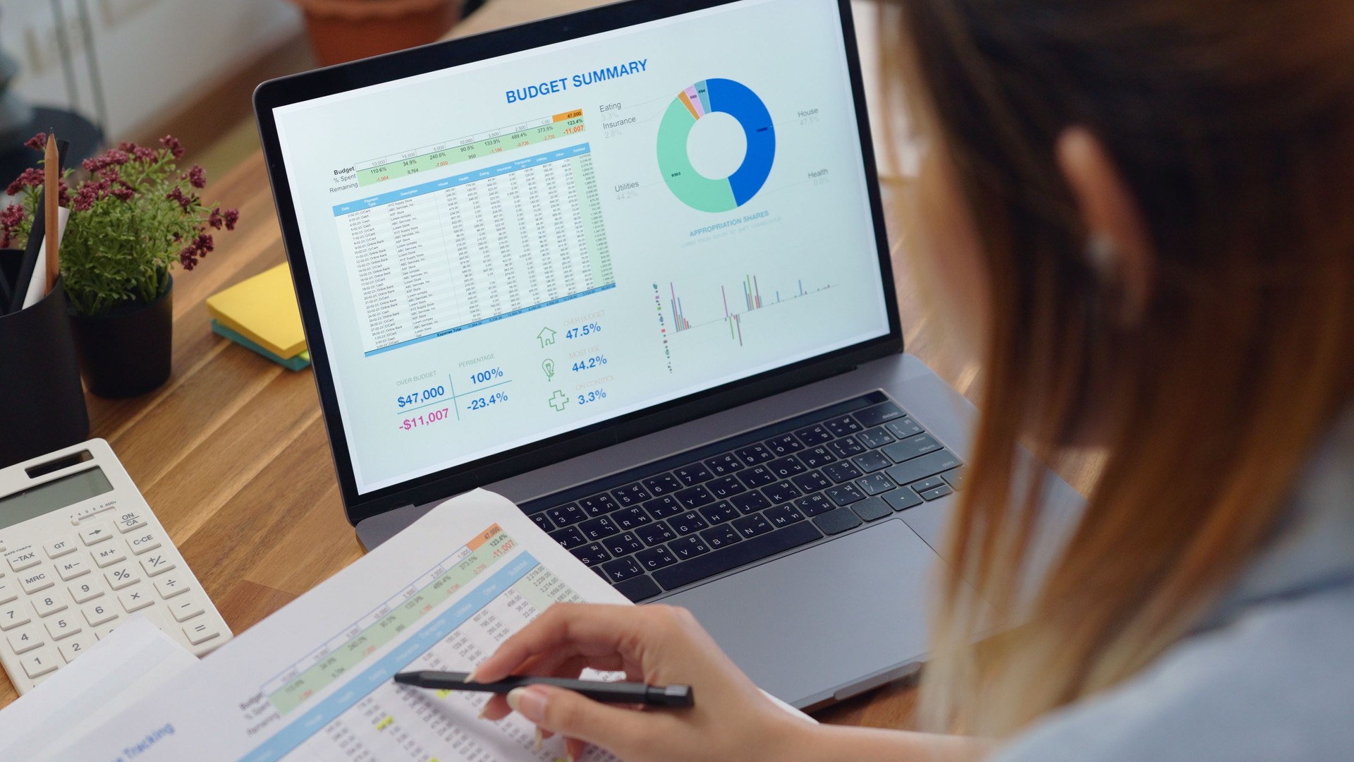 close up  woman hands calculates on calculator for personal finance, paysckeck paper receipt expense biil statement,planning budgets of monthly personal balance at home.